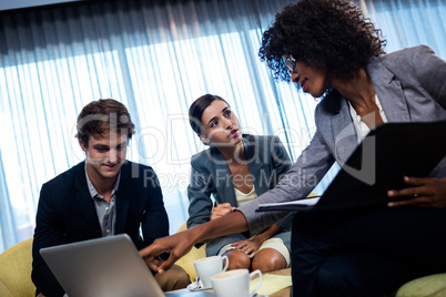 Coworkers having meeting around table