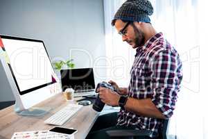 Side view of hipster working at desk