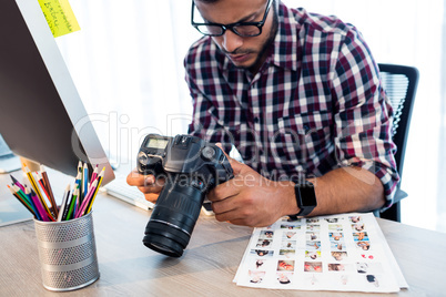 Side view of photographer working at desk