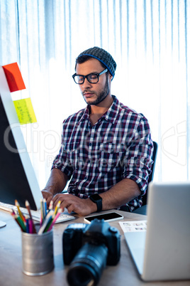 Photographer working at computer desk