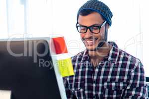 Portrait of smiling hipster working at desk