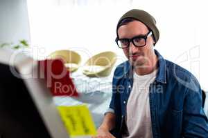 Portrait of smiling man working at computer desk