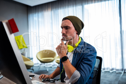 Concentrated hipster man working with audio headset