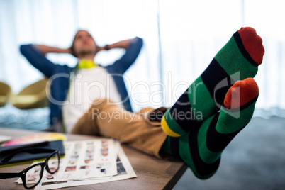 Casual man resting with feet on his desk