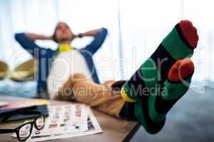 Casual man resting with feet on his desk
