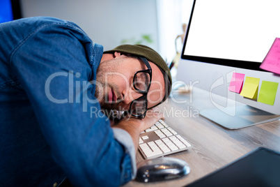 Hipster businessman sleeping at his desk