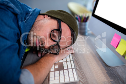 Hipster businessman sleeping at his desk