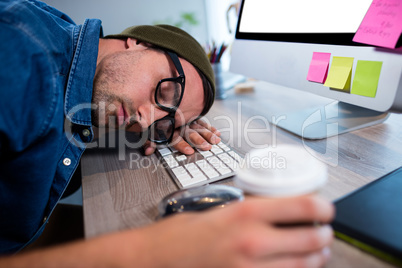 Hipster businessman sleeping at his desk