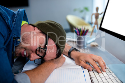 Hipster businessman sleeping at his desk