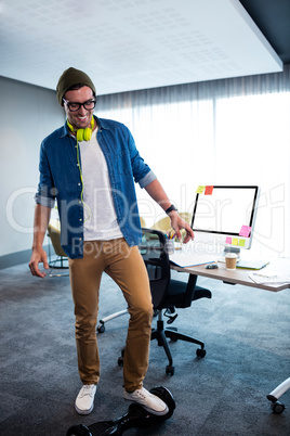 Hipster man using a smart balance wheel