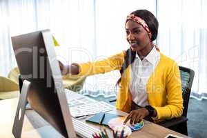 Business woman pointing at her screen