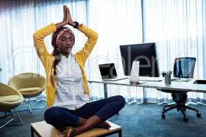 Businesswoman doing yoga