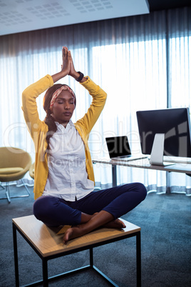 Portrait of businesswoman doing yoga