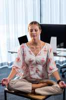 Portrait of businesswoman doing yoga