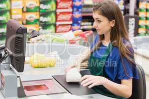 Woman cashier beeping an item