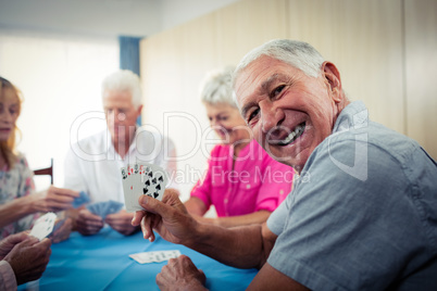 Group of seniors playing cards