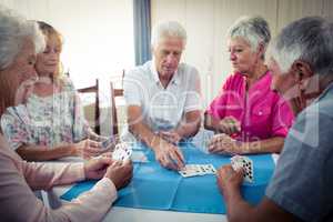 Group of seniors playing cards