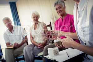 Seniors talking with nurse about medication