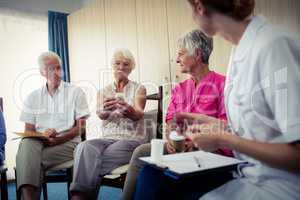 Seniors talking with nurse about medication