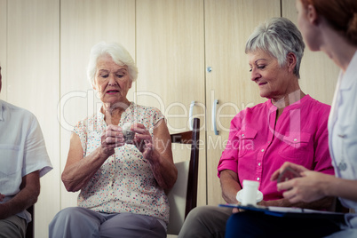 Seniors talking with nurse about medication