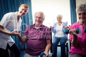 Group of seniors doing exercises with nurse