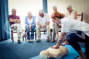 Nurse teaching first aid to a group of seniors