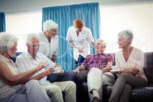 Seniors interacting with nurse