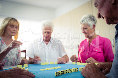 Group of seniors playing dominoes