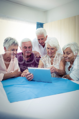 Group of seniors using a tablet computer