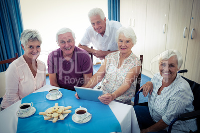 Group of seniors using a tablet computer