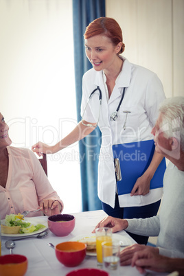 Pensioners at lunch with nurse