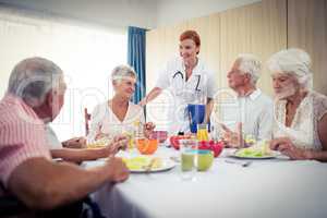 Pensioners at lunch with nurse