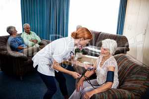 Nurse taking care of pensioner