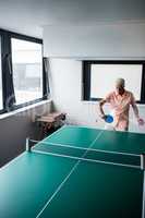 Senior playing ping pong