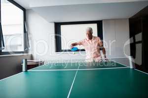 Senior playing ping pong