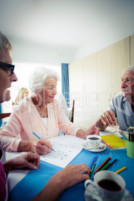 Group of seniors drawing and interacting