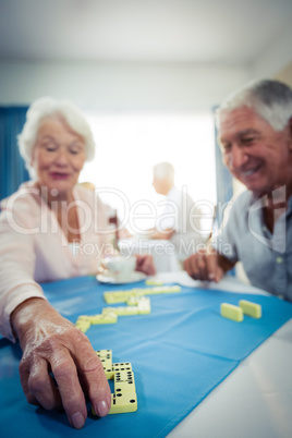 Group of seniors playing dominoes