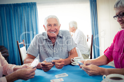 Group of seniors playing cards