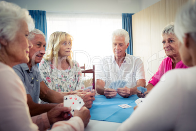 Group of seniors playing cards