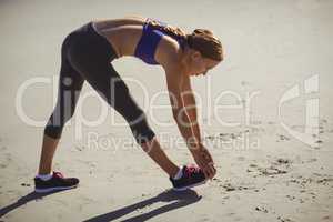 Fit woman warming up on beach