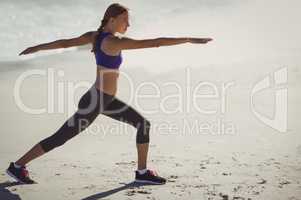 Fit woman warming up on beach