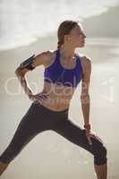 Fit woman warming up on beach