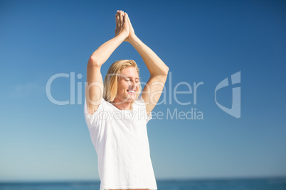 Man performing yoga on beach