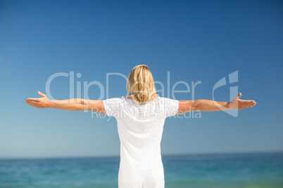 Man standing with arms stretched