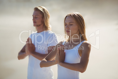 Man and woman performing yoga