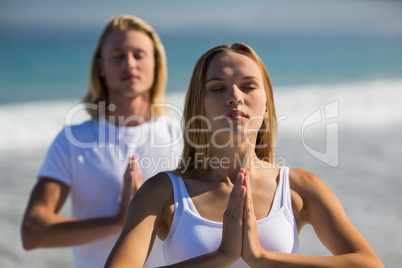 Man and woman performing yoga