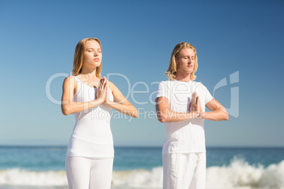 Man and woman performing yoga