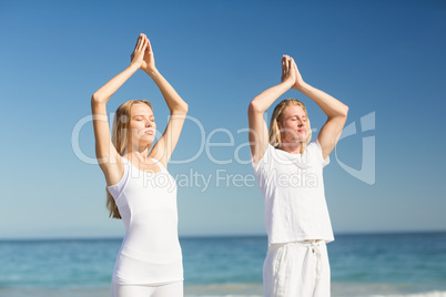 Man and woman performing yoga