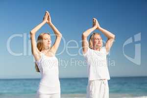 Man and woman performing yoga