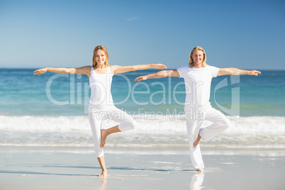 Man and woman performing yoga